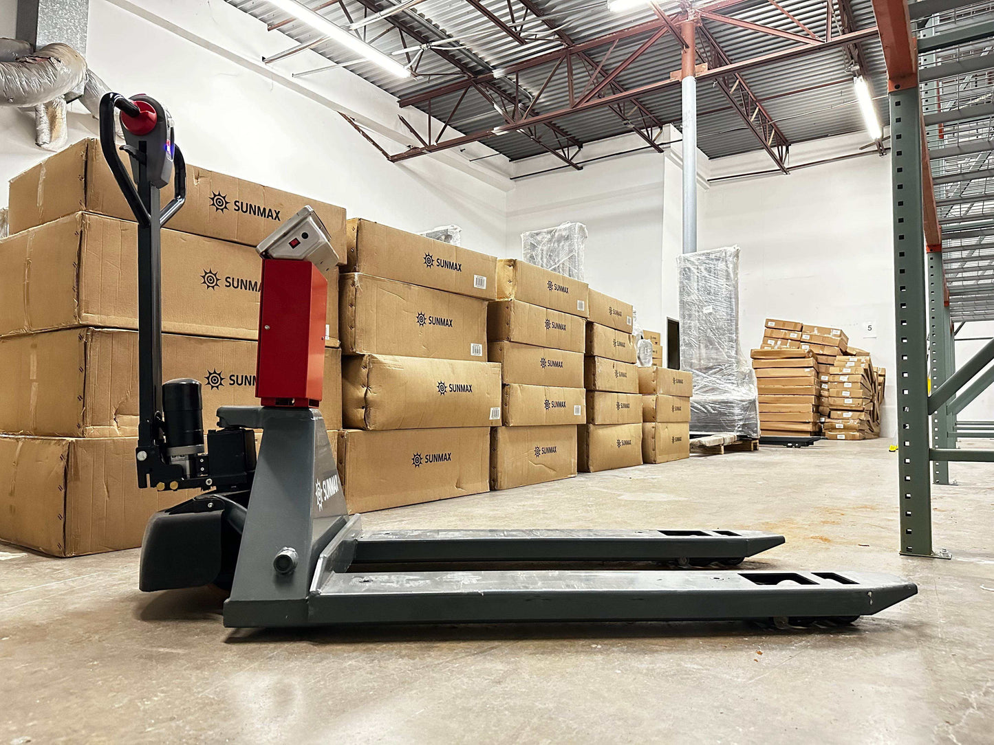 PT4400W Electric Pallet Jack with built-in scale in warehouse setting, 4400 lbs capacity, 45" x 27" forks, electric brake