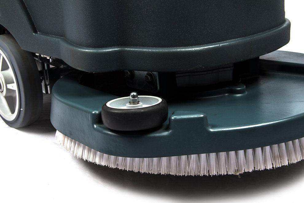 Close-up of 22-inch brush scrubbing path on battery-powered floor scrubber machine for warehouse cleaning