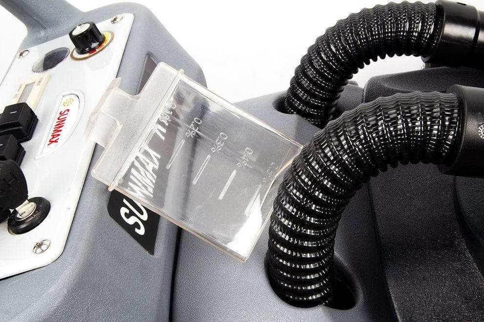 Close-up of control panel and hoses on RT50 battery powered walk-behind floor scrubber with 22-inch brush cleaning path.