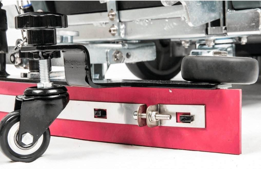 Close-up of RT50 battery powered walk-behind floor scrubber wheel and brush mechanism with red baseplate