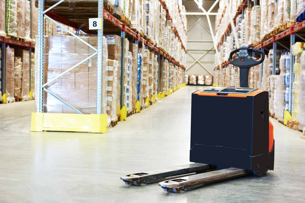 An empty electric pallet truck in a warehouse.